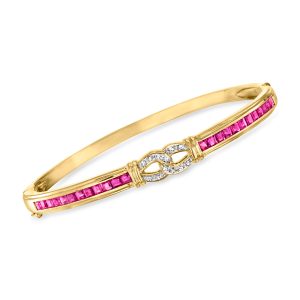 C. 1990 Vintage 2.40 ct. t.w. Ruby and .10 ct. t.w. Diamond Bangle Bracelet in 14kt Yellow Gold. 7"